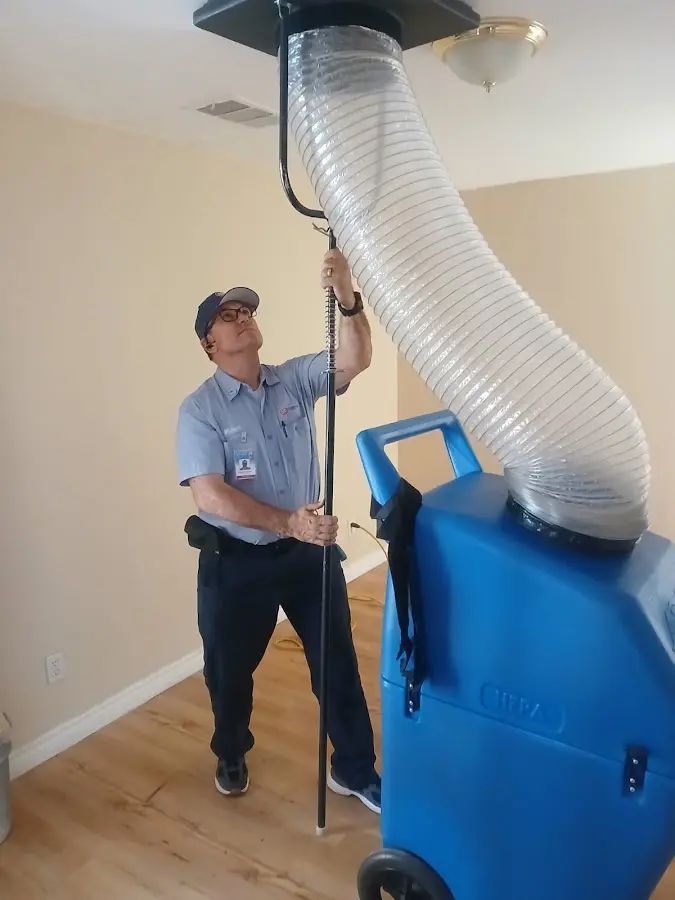 Furnace Tune-Up technician using HEPA equipment in Genoa